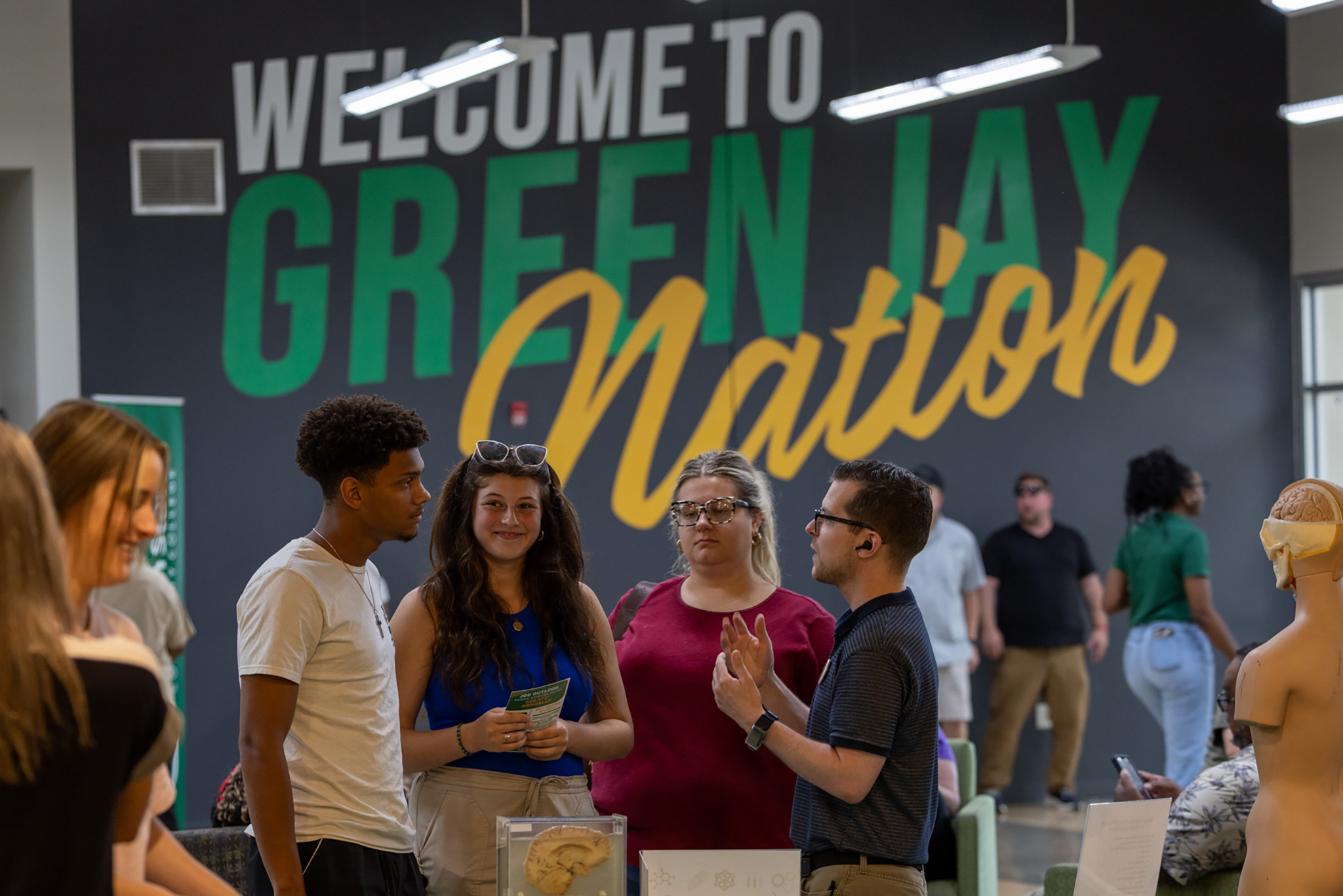 Professor Jason Keeton talks to a group of people in the JSCC Student Center on July 19 during the Fall 2025 Open House.